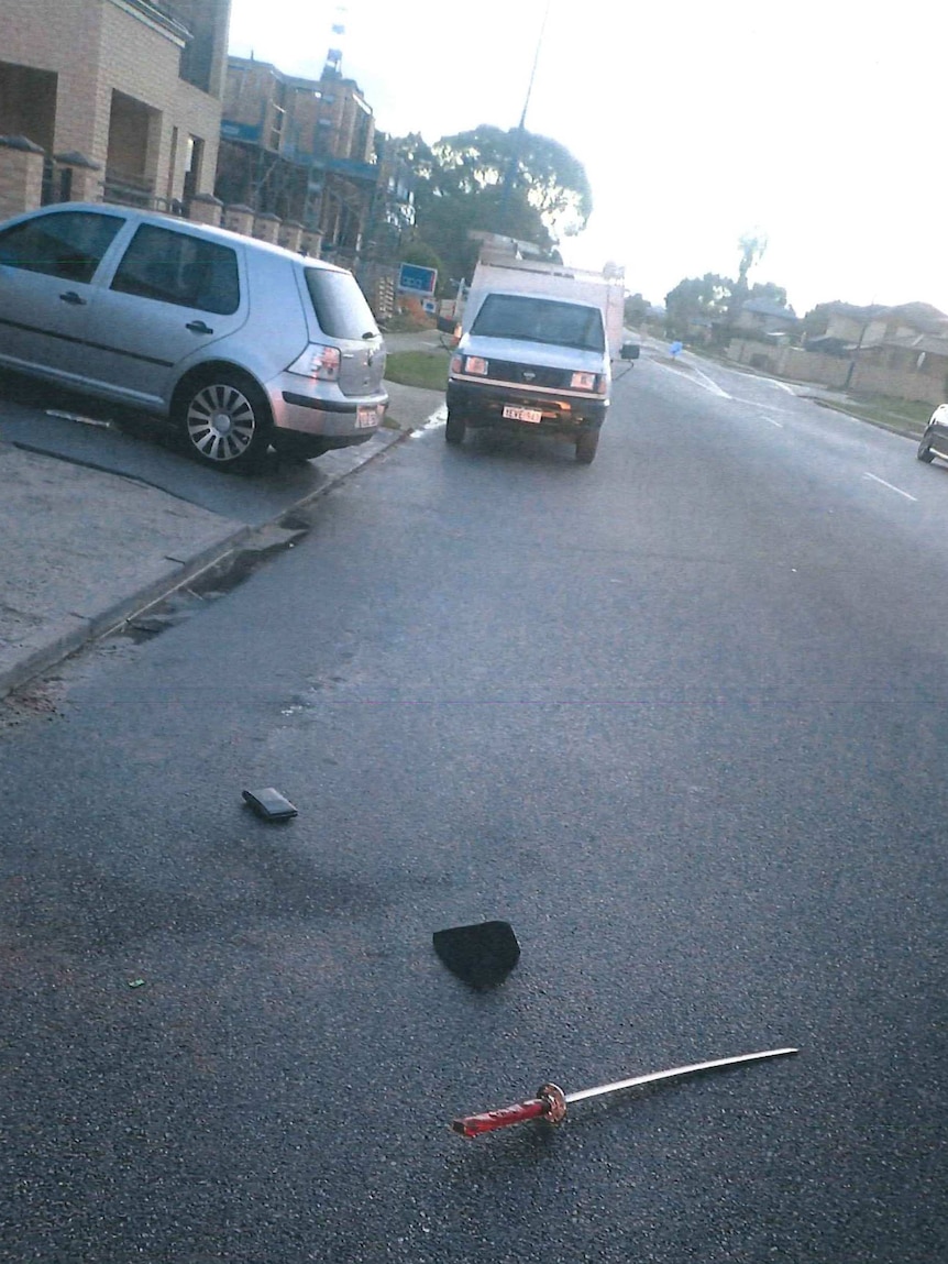 A samurai sword on a suburban bitumen road.