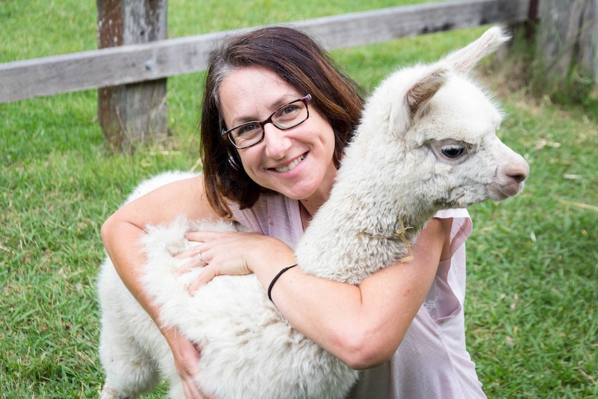 Daniela Riccio holds an alpaca.