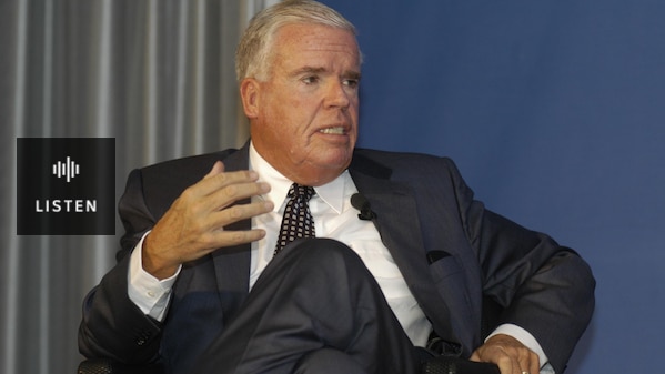 Klaus-Michael Kühne wearing suit, seated and gesturing with hand. Has Audio.