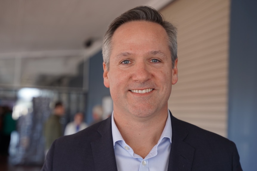 A man wearing a suit smiling