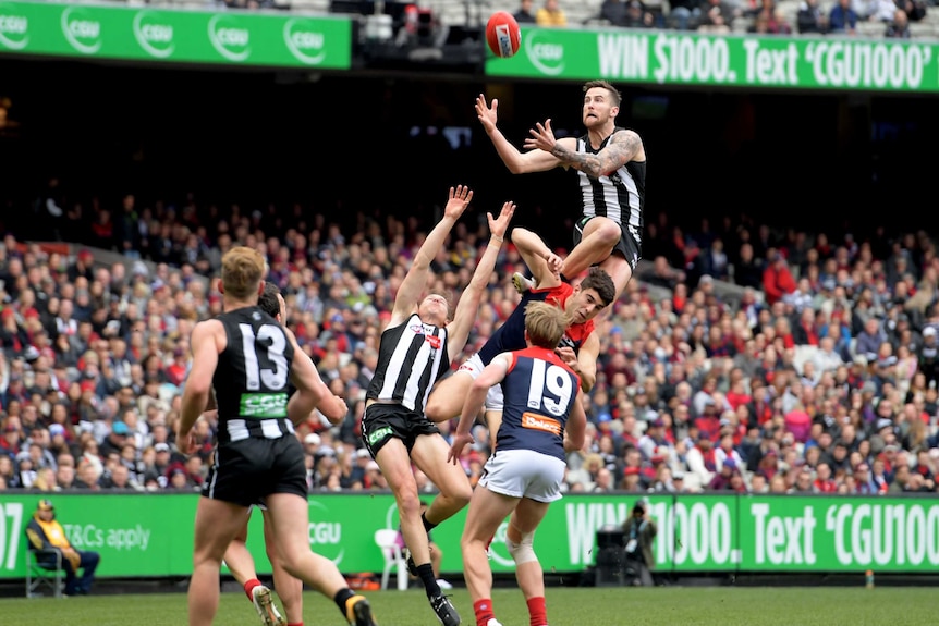 Jeremy Howe takes a massive speckie, standing on Christian Petracca's head as the ball arrives.
