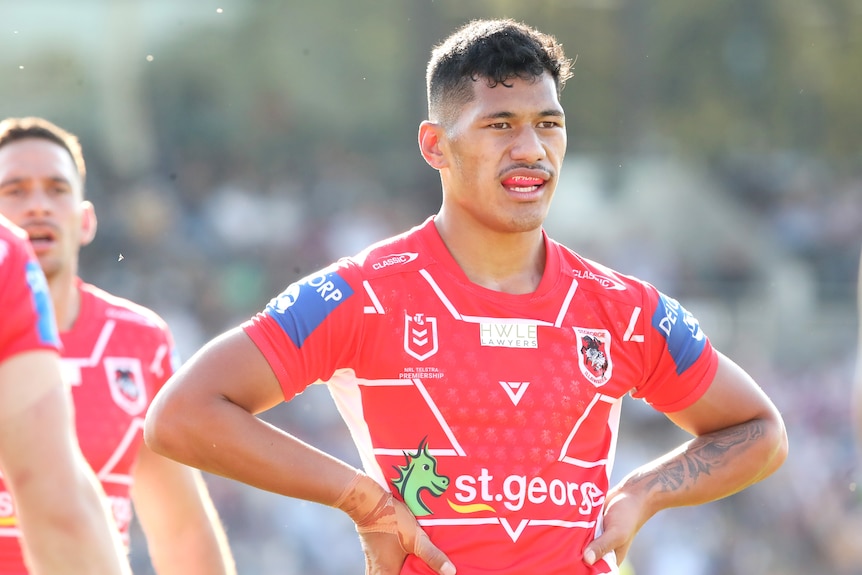 a St George Illawarra NRL player stands with his hands on his hips.