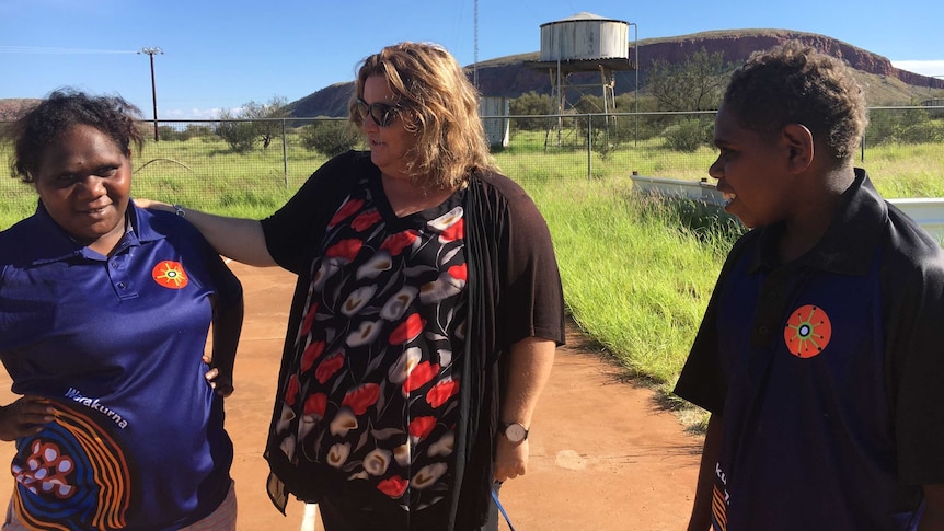 Sandy Robertson with a teacher and a student in Warakurna.
