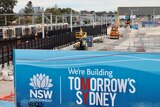 Construction site for Sydney's new metro line with sign saying we're building tomorrow's Sydney