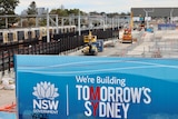 Construction site for Sydney's new metro line with sign saying we're building tomorrow's Sydney