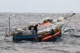 Crew from French fisheries patrol vessel Osiris approach the demasted Thuriya to rescue Abhilash Tomy