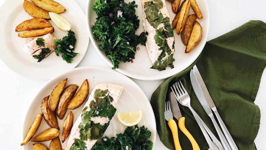 Two adult servings of salmon, potato wedges and kale salad with one kid sized serving from our easy recipe.