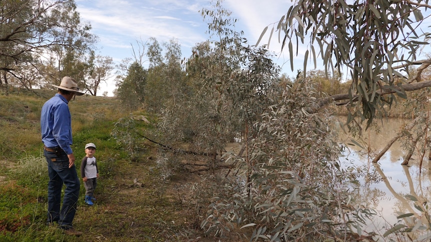 Michael Marshman and son on his carbon farming property by a dam.