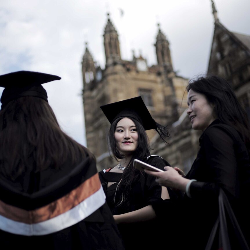 An international university student wears her mortar hat following her graduation ceremony.
