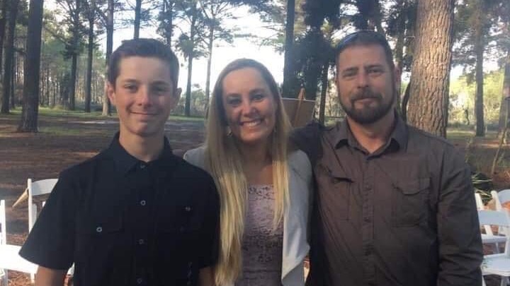 A teenage boy who died in a motocross accident is pictured with his parents.  