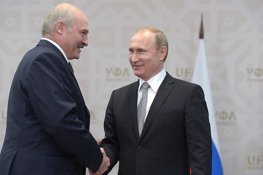 Belarus President Alexander Lukashenko shakes the hand of his Russian counterpart Vladimir Putin at a meeting in 2015.