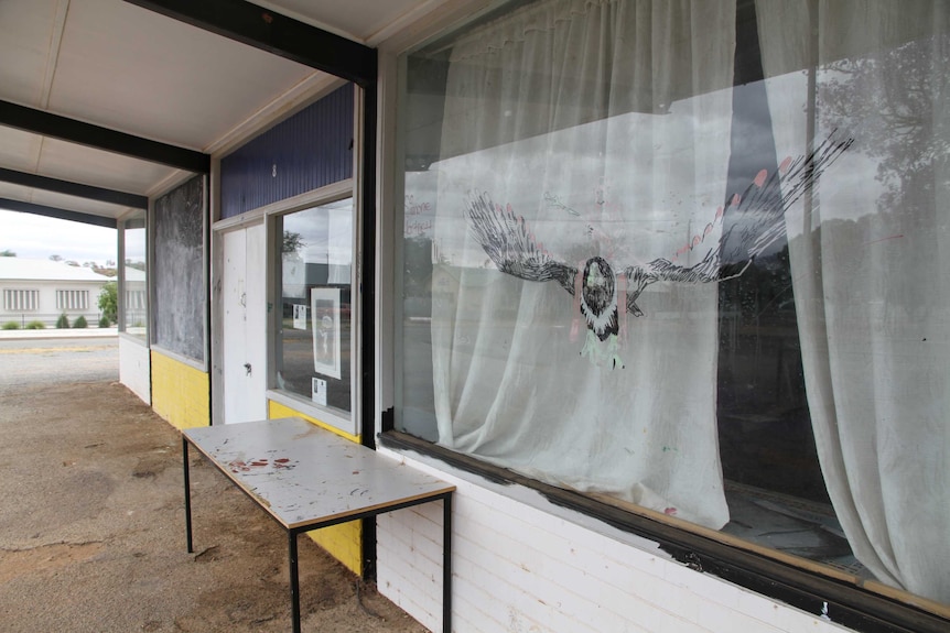 A cartoon eagle is drawn on a large window of the building where students in Broken Hill attend