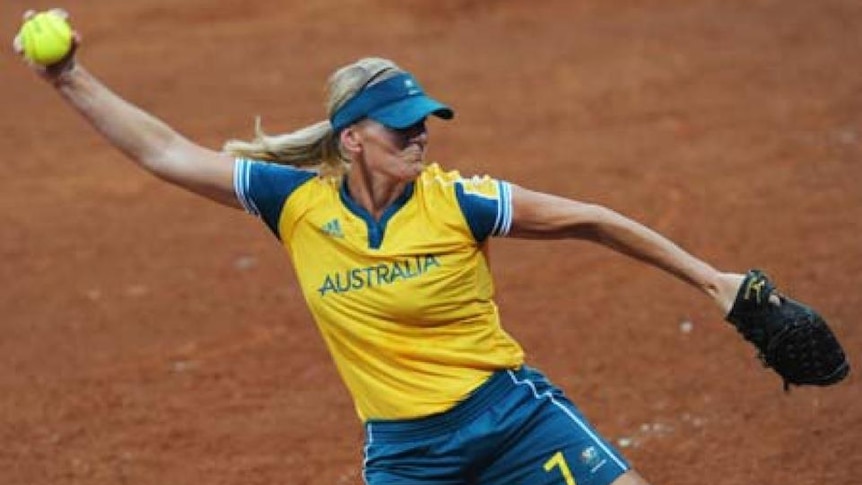 Tanya Harding pitches a softball dressed in Australian team uniform