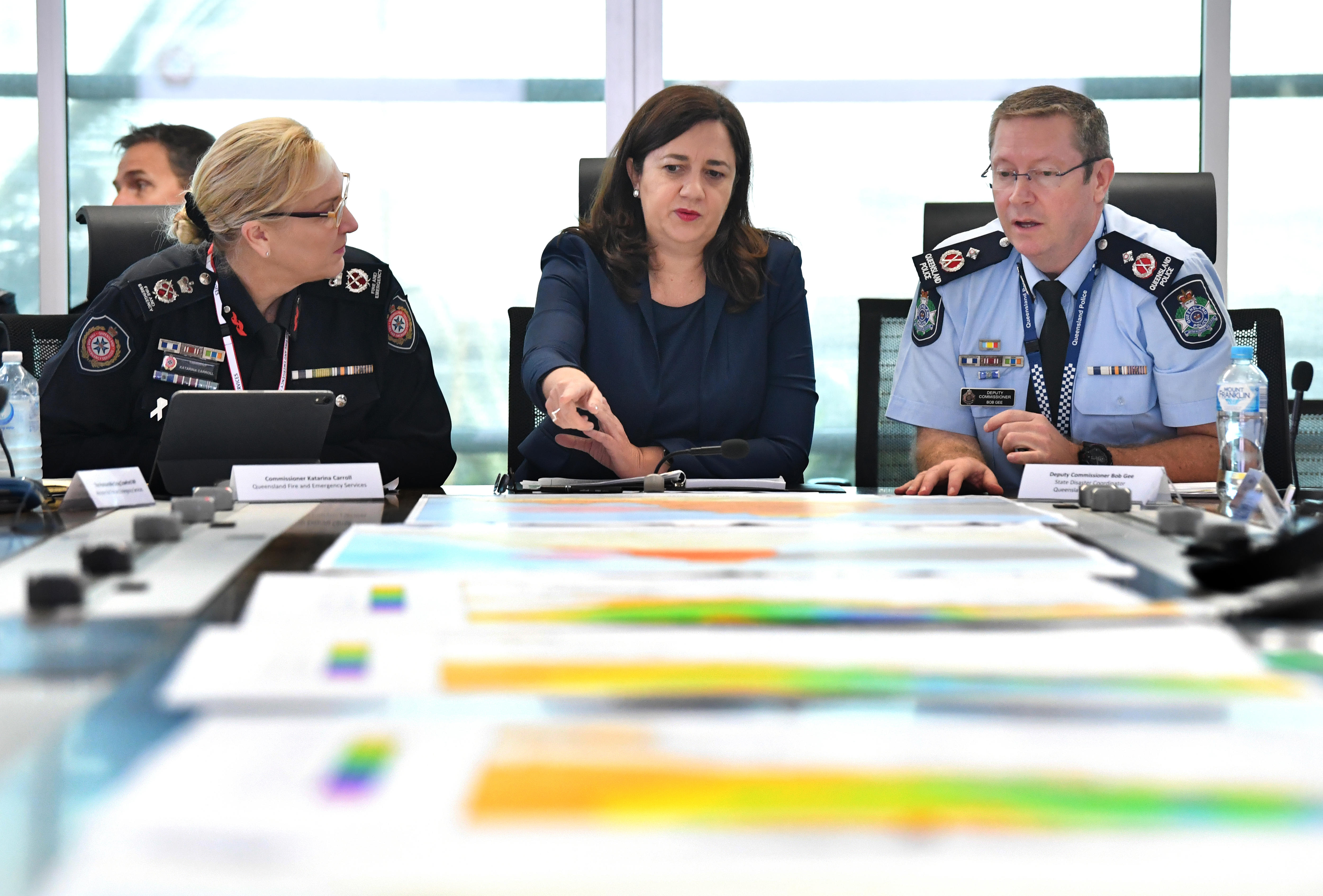 carroll, premier and police deputy commission looking over maps