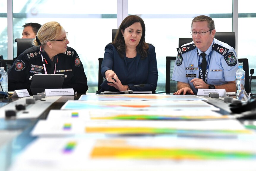 carroll, premier and police deputy commission looking over maps