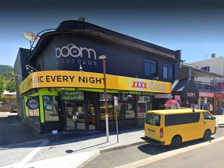 A streetview of a nighclub during the day, with a yellow van parked out the front.