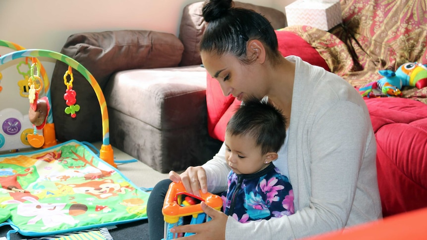 Natasha Quintanilla plays with her daughter Maya.