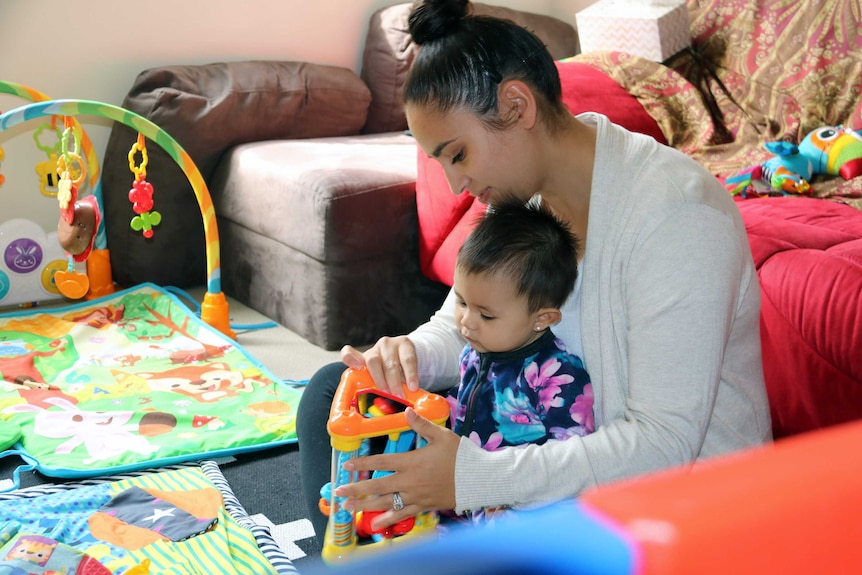 Natasha Quintanilla plays with her daughter Maya.