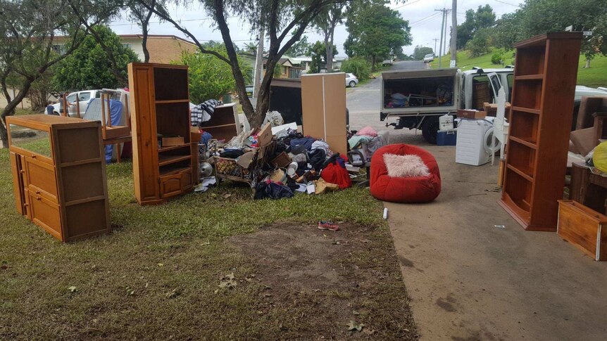 Kristy Barendrecht's flood damaged household goods piled on the side of the road