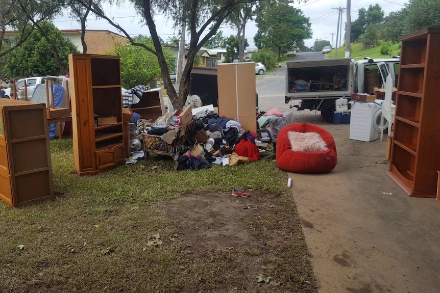 Kristy Barendrecht's flood damaged household goods piled on the side of the road