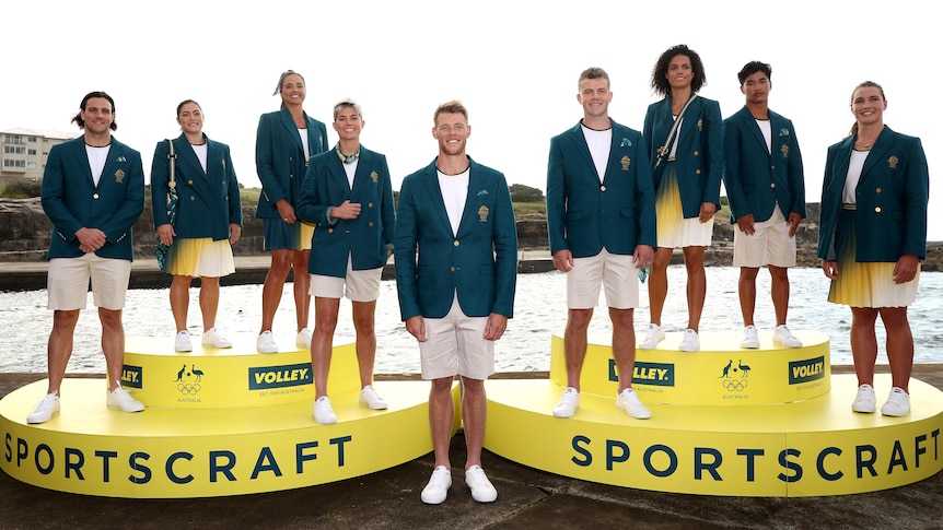 Nine Australian Olympians pose for photos in their outfits for the Paris Olympic Games opening ceremony.