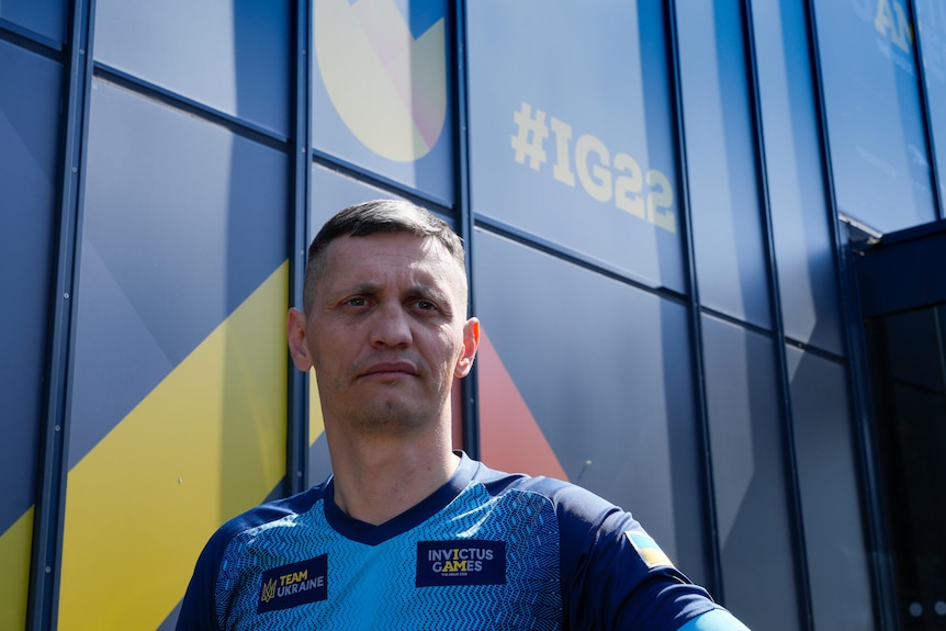 a close up shot of an athlete in an Team Ukraine Invictus Games unfirom looking towards the camera 