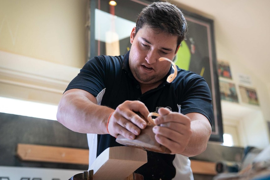 Josh Gavan gets to work on one of the precious blades in his workshop in his parents' garage in Bondi