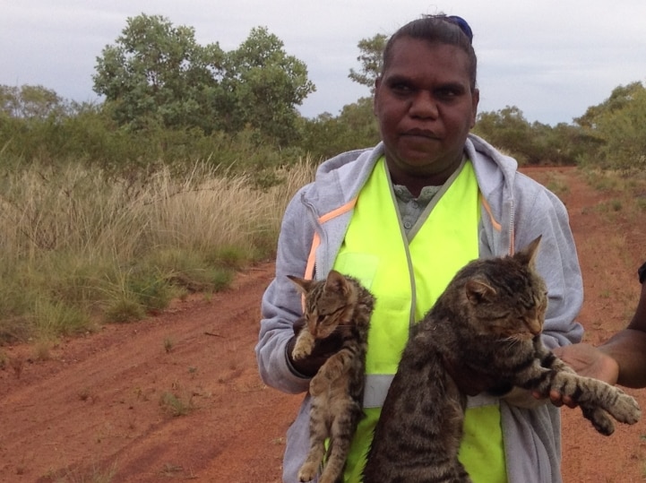 Indigenous woman holding feral cat