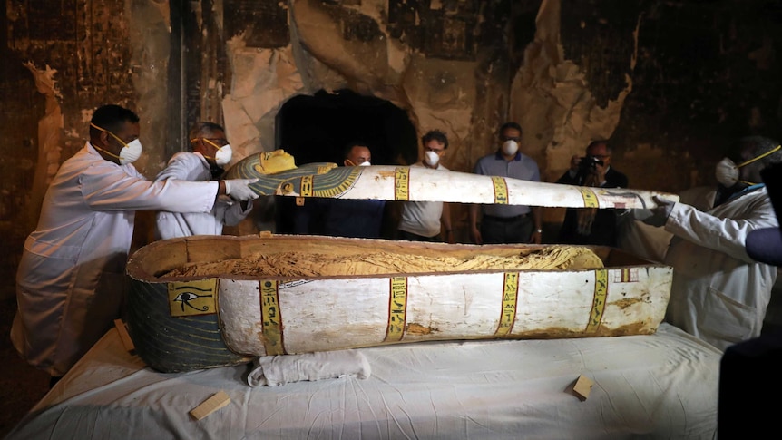 Media look on as a previously unopened sarcophagus is revealed. (Image: Reuters/Mohamed Abd El Ghany)