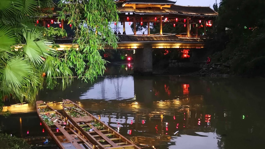 The two capsized dragon boats are seen in the river.