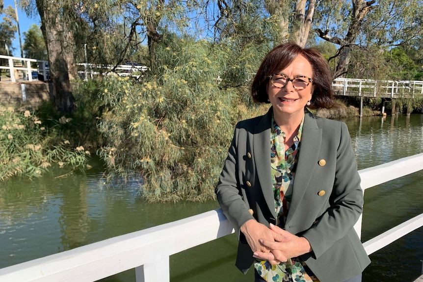 woman standing smiling next to the Murray River