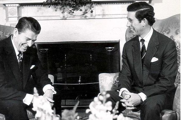 A black and white photo shows Ronald Reagan and Prince Charles at the White House