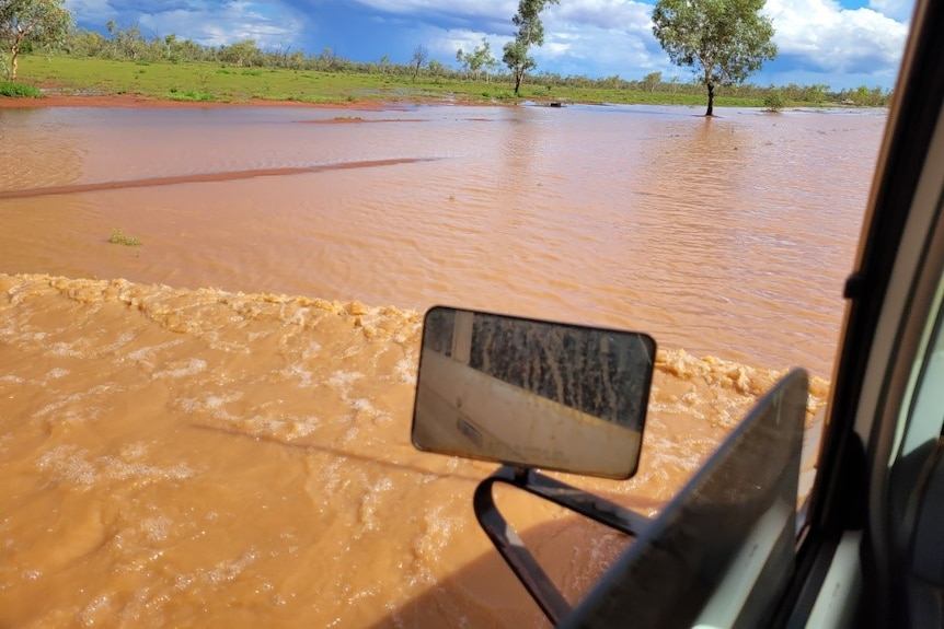 Floodwater and a vehicle's sideview mirror.