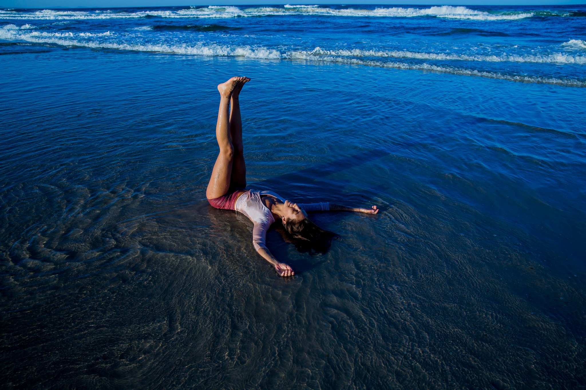 Lara, blissing it up on the shores of a Northern Riverina beach in a restorative yin posture.