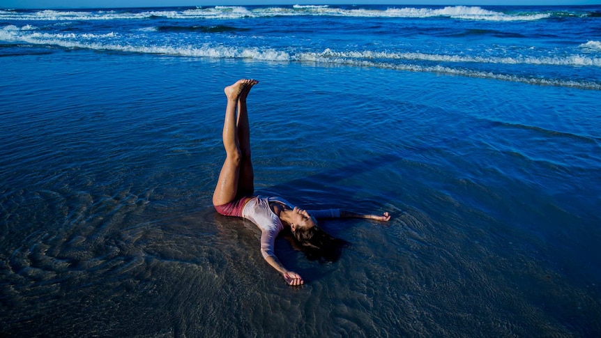 Lara, blissing it up on the shores of a Northern Riverina beach in a restorative yin posture.