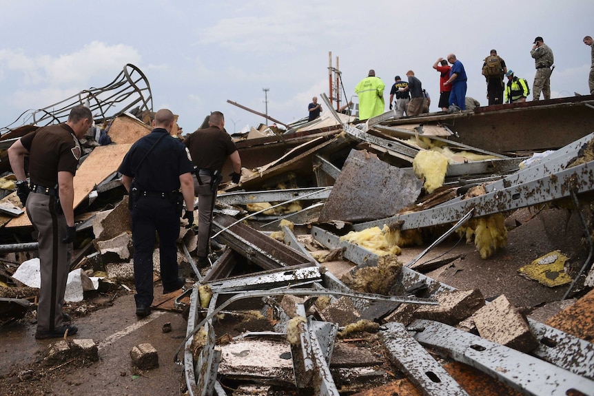 Rescue workers search for survivors among the wreckage.