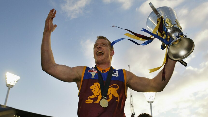 AFL player Michael Voss celebrates with the cup after the AFL Grand Final in 2003