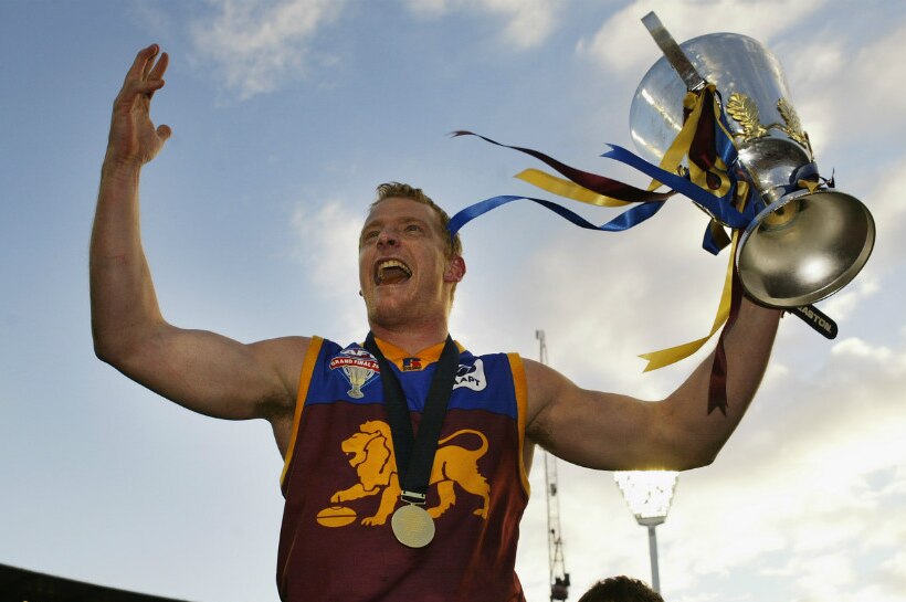 AFL player Michael Voss celebrates with the cup after the AFL Grand Final in 2003