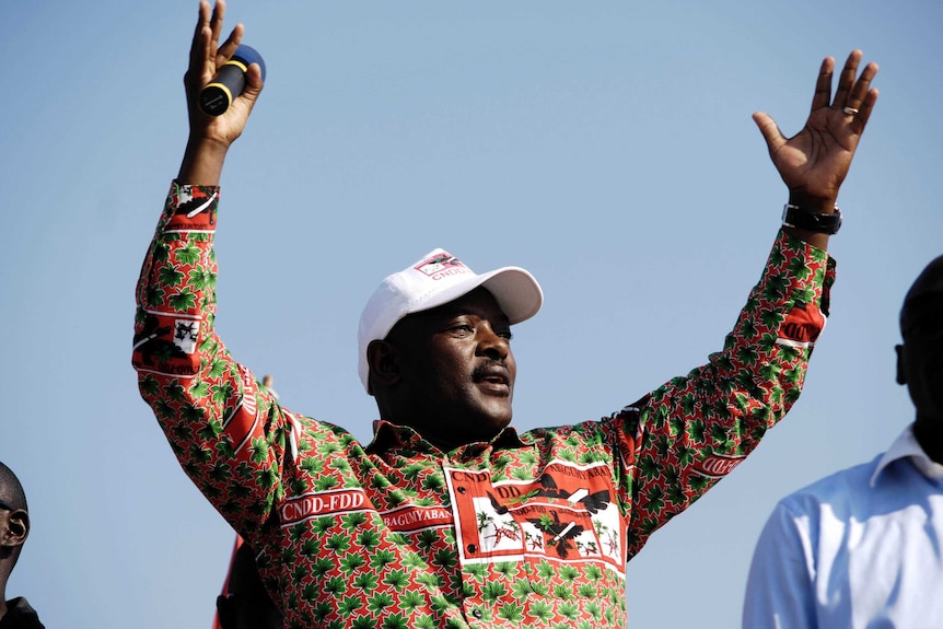 President Pierre Nkurunziza raises both hands in the air as he gestures to supporters.