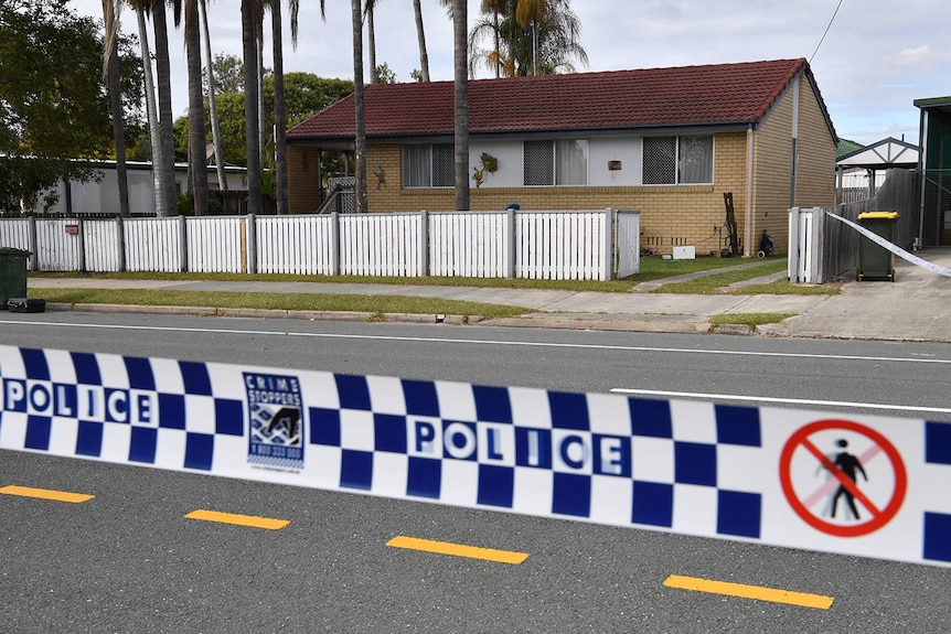 Police tape outside a house at Deception Bay where a Clinton Pollock was shot and killed.