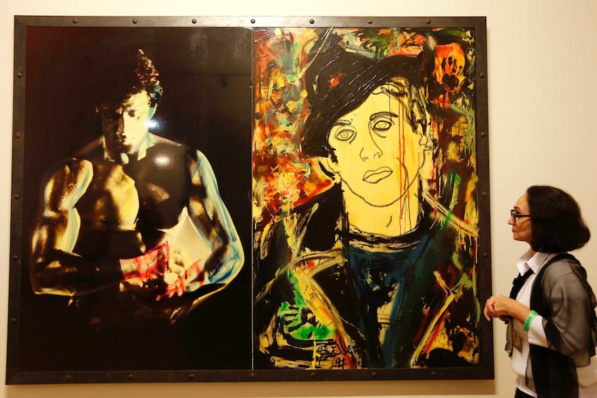 A woman at the art exhibition, Sylvester Stallone. Painting. From 1975 Until Today.