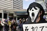 A protester wearing a scream mask at a rally in Tokyo against nuclear power on March 27, 2011.