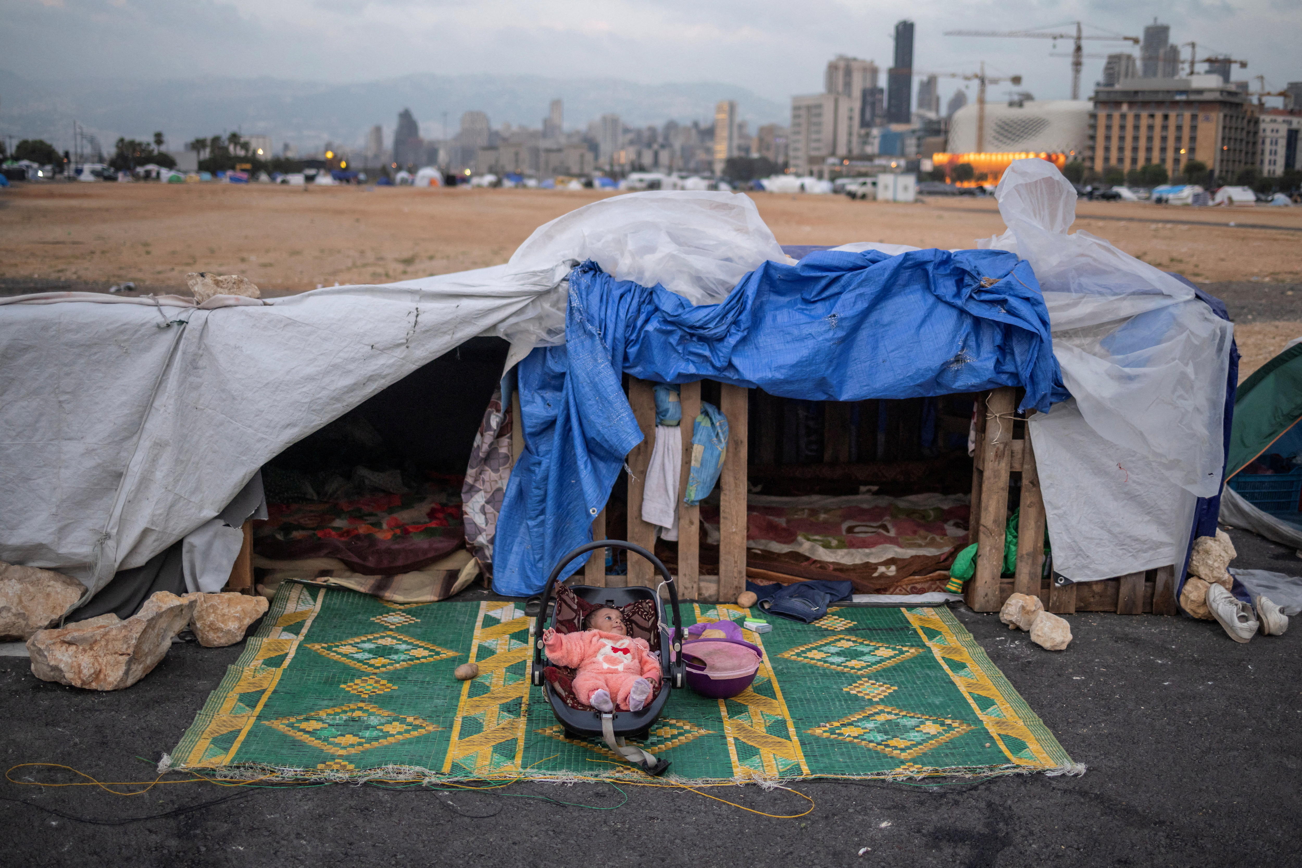 Alin, a two-months-old displaced baby girl, lies in her cradle at a makeshift encampment.