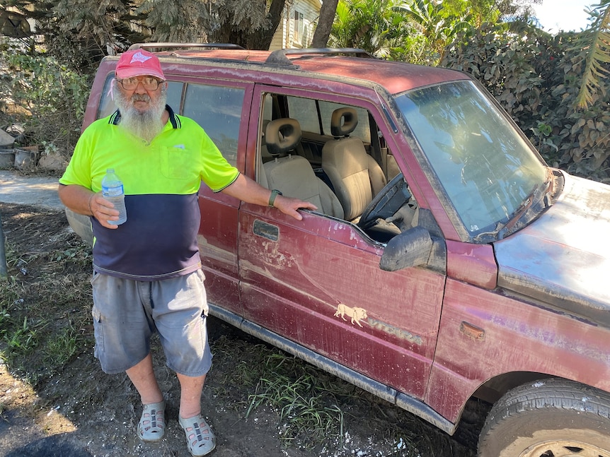 Allan Kunst with his wife's flooded car