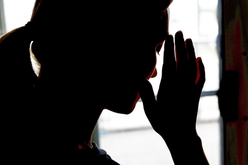 A woman shielding her face