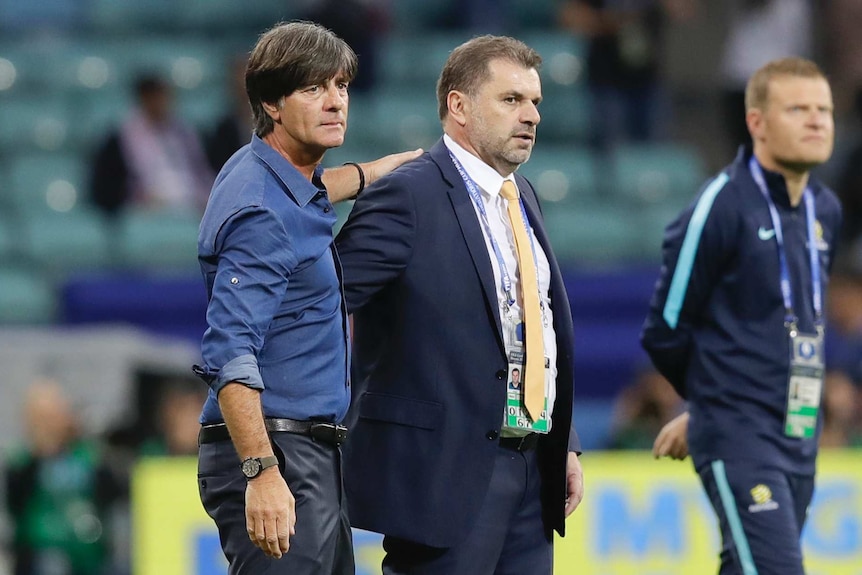 Germany coach Joachim Loew (L) greets Australia's Ange Postecoglou after Confederations Cup match.