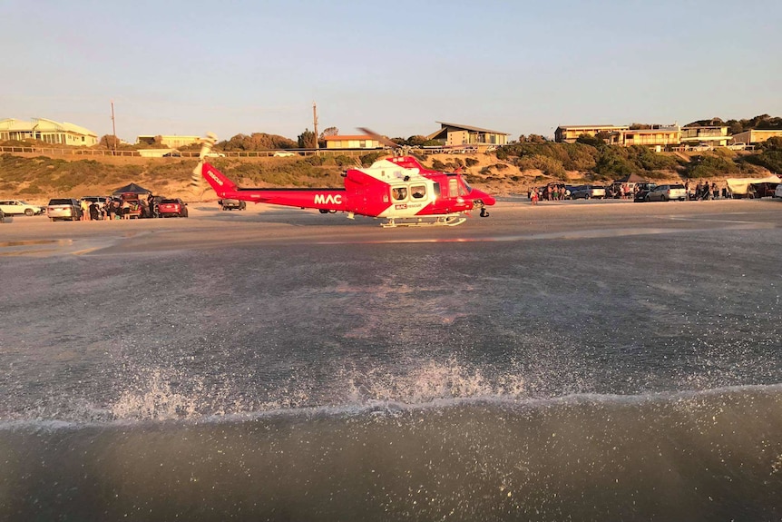 A helicopter hovering over the water