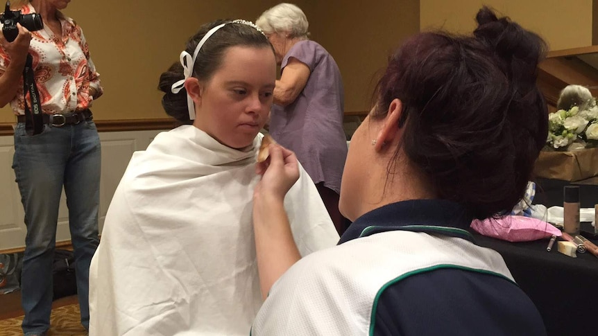Taylor Anderton gets her makeup done ahead of the Gold Coast Debutante Ball for young women with disabilities