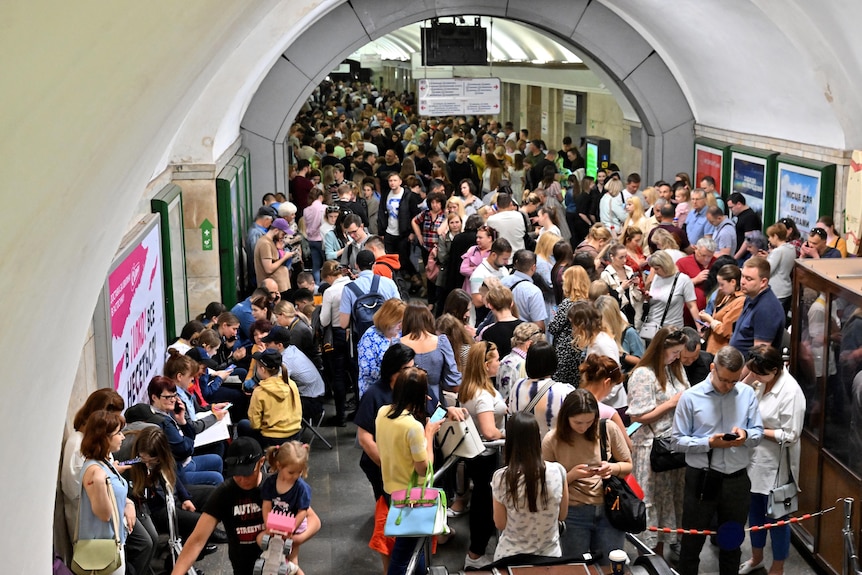 Local residents take shelter in a metro station in the centre of Kyiv during a Russian missile strike.