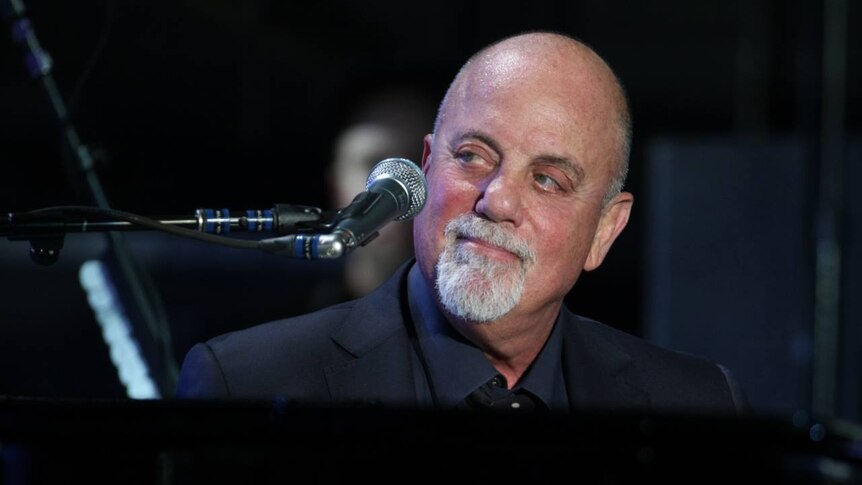 Close up of Billy Joel performing at a piano